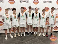 a group of boys posing for a picture in front of a banner