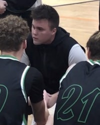 a group of basketball players are huddled together